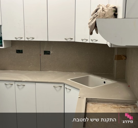 מטבח עם משטחי שיש וכיור מותקן